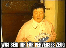 a woman wearing a los angeles nfl sweatshirt is standing in front of a door