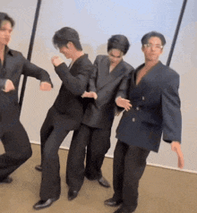 a group of men in suits are dancing together in a room