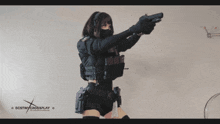 a woman holding a gun with destiny crossplay on the bottom