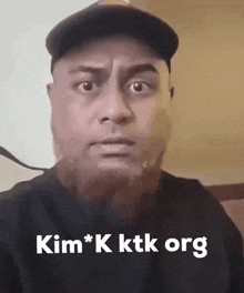 a man wearing a hat says kim * k ktk org on the bottom