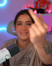 a woman wearing a berserk t-shirt giving the middle finger