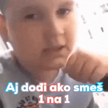 a baby is pointing at the camera with the words aj dodi ako smes 1 na 1