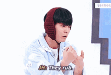 a young man wearing a knitted hat is saying jh they rub