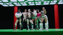 a group of women are standing on a stage and one of them is wearing a furry boot