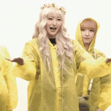 a woman wearing a yellow raincoat and a flower crown