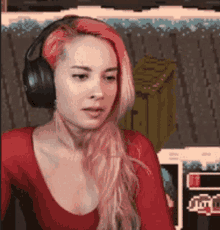 a woman with red hair is wearing headphones and a red shirt