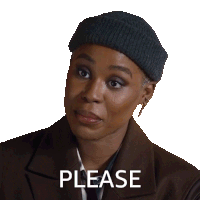 a woman wearing a beanie and a brown jacket is smiling and says please