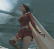 a woman in a red and gold superhero costume