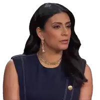 a woman wearing dior earrings and a necklace