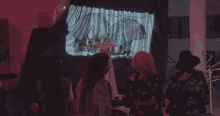 a woman wearing a mask stands in a dark room