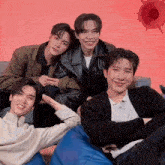 a group of young men are posing for a picture together and smiling