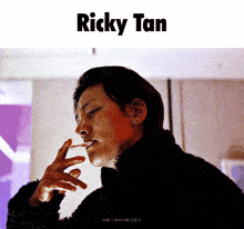 a man smoking a cigarette with the name ricky tan on the bottom
