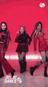 a group of girls are performing a relay dance on a red background