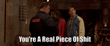 a man says you 're a real piece of shit in front of a woman