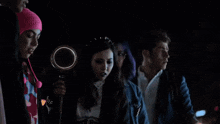 a group of people looking up at a light