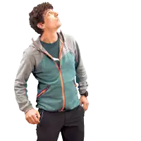 a man with his hands in his pockets looks up at the sky