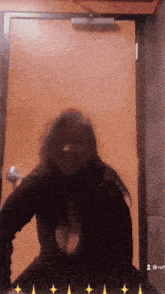 a woman is standing in front of a door with a blurred image of her