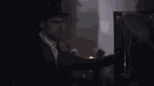 a man in a top hat is looking at something