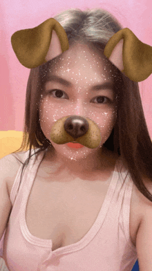 a girl with a dog mask on her face looks at the camera