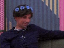 a man wearing a flower crown on his head .
