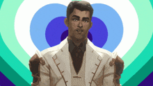 a man in a white suit stands in front of a heart