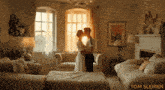 a man and woman kissing in a living room with tom slemen written on the bottom