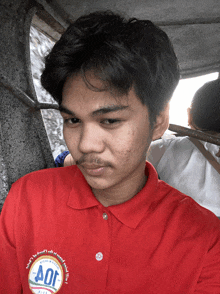 a young man wearing a red shirt that says joy on it