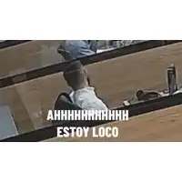 a man is sitting in a row of chairs in a lecture hall with a backpack on his back .