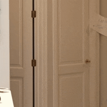 a woman in a cat costume stands in front of a white door