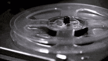 a close up of a tape reel on a record player .