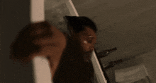 a blurry picture of a man in a black jacket holding a bottle