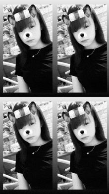 a black and white photo of a girl wearing a cat mask on her face