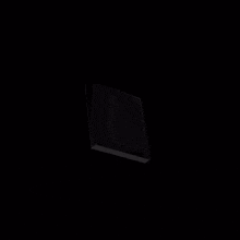 a silver square with a hole in the middle is against a black background