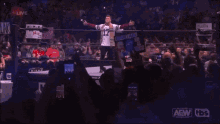 a man in a red shirt with the word aew on the bottom
