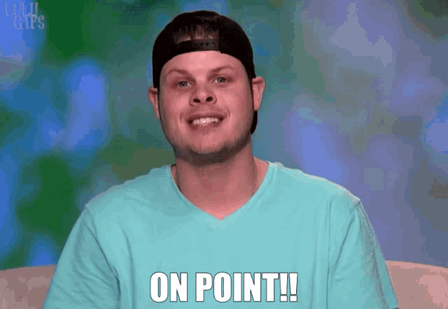 a man wearing a hat and a blue shirt says 