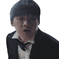a man in a tuxedo and bow tie is making a funny face