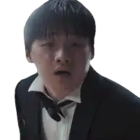 a man in a tuxedo and bow tie is making a funny face