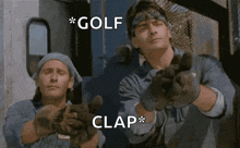 a couple of men are standing next to each other and one of them is wearing gloves and the other is wearing a bandana