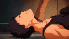 a man in a black tank top is laying on the floor with his eyes closed