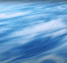a close up of a blue sky with white clouds .