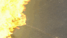 a person in a black and orange suit is surrounded by fire