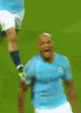 a blurry picture of a soccer player wearing a blue jersey