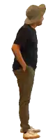 a man wearing a hat and a black shirt is waving at the camera