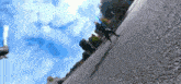 a person riding a skateboard down a street with a blue sky in the background