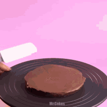 a chocolate cake on a black plate with mr.cakes written on it