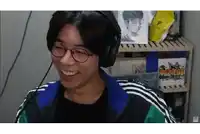 a man wearing headphones and glasses is smiling