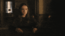 a close up of a woman 's face in a dark room