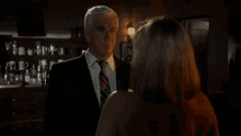 a man and a woman are standing next to each other in a room . the man is naked and the woman is naked .