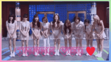 a group of girls are bowing in front of a building with the words thank you written in red hearts .