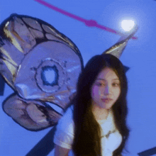 a woman wearing a butterfly costume is standing in front of a blue wall